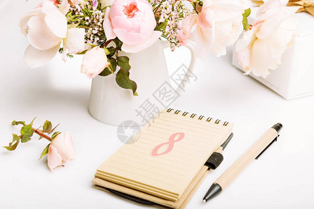 妇女节假日卡概念美丽的鲜粉色英式玫瑰礼物带文字8的笔记本钢笔图片