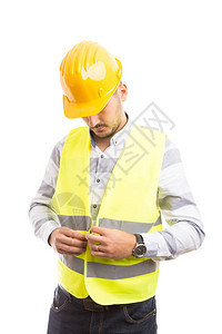 以绿色反光背心和黄色安全帽为保护和安全设备概念的建筑工人或图片