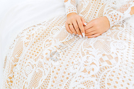 紧握着新娘的手她坐在一件美丽的裙子图片
