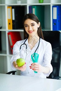 健康室里幸运营养师的画像持有青苹果和厘米丝带健康的营养新鲜蔬菜和图片