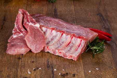 鲜切羊肉在木背景的生猪肉背景