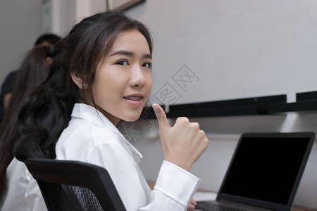 自信的亚洲年轻商业女青年在办公室工作时图片