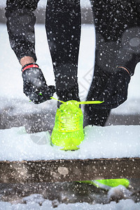 锻炼身体在白雪皑的公园系鞋带的男人背景