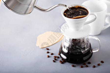 倒在咖啡上用茶壶和玻璃杯来泡咖啡图片