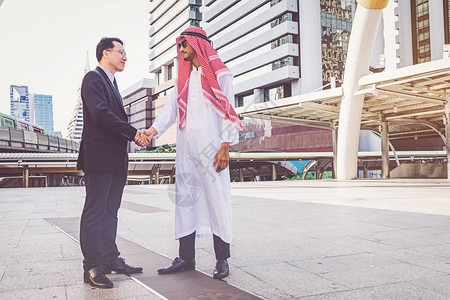 阿拉伯商人在建筑工地上与商业伙伴握手图片