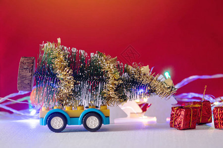 玩具车在蓝色背景的圣诞节和除夕夜运载礼物假日购物图片