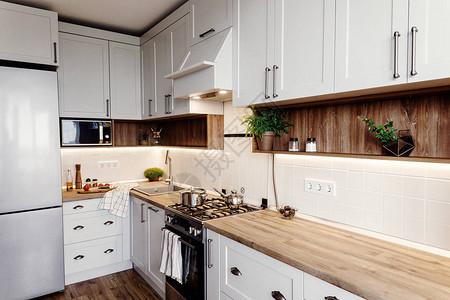 时尚的厨房室内设计灰色的豪华现代厨房家具和钢烤箱冰箱水槽木桌面锅斯堪的纳维亚风格的灰色橱背景图片