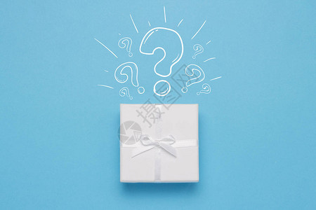 蓝色背景上的白色礼品盒和图标问号简约风格概念惊喜和悬念图片