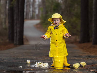 垃圾桶卡通一个小孩在雨中玩耍而小妞背景