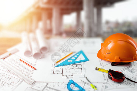 橙色头盔铅笔建筑施工图卷尺建筑建筑工程设计的概背景图片