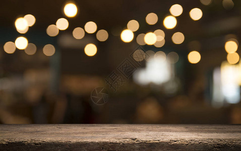 深色背景下咖啡馆餐厅模糊浅金色散景上的空木桌面背景图片