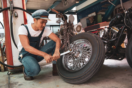 保养和维修车间摩托车的机械技工人手保图片