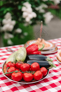 新鲜和天然蔬菜多汁的西红柿茄子甜椒西葫芦在户外餐桌上为客人提供有用和美味的款待在新背景图片