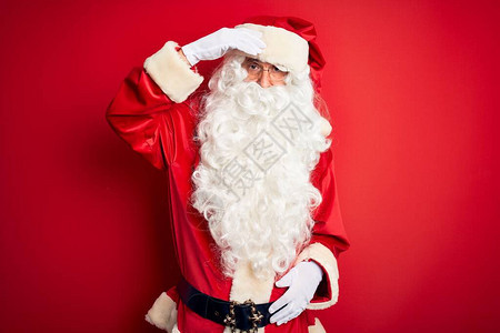 身着圣诞老人服装的中年英俊男子站在孤立的红色背景之上感到担忧图片