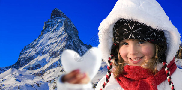 在雪地滑雪坡和背面的马特霍恩描绘着快乐的年图片