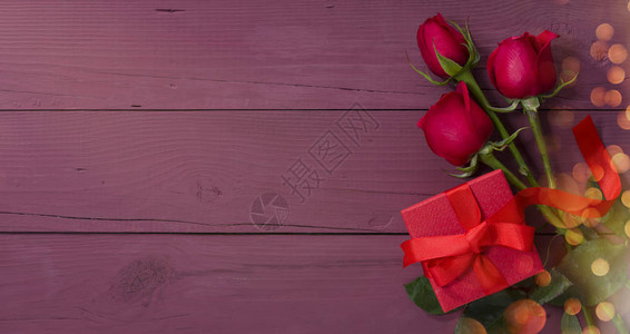 情人节卡片紫色木桌上的红色礼盒和玫瑰图片