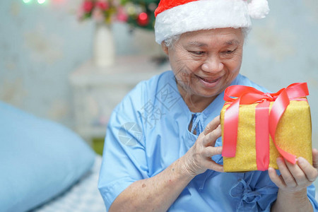 亚洲老年或老年妇人患者戴着圣诞老人助手帽图片