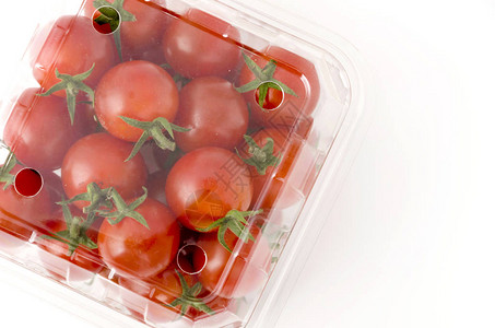 塑料容器里有樱桃西红柿白色背景的盒子里有新图片