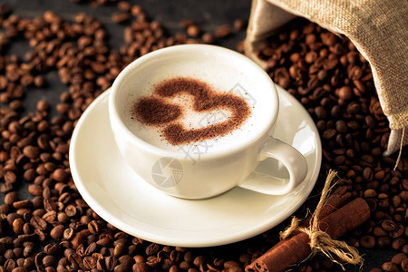咖啡豆背景的心形拿铁艺术图片