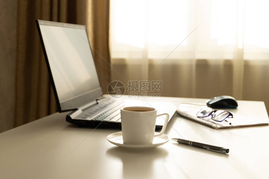 办公室的概念工作场所与笔记本电脑进行自由职业早上班前喝咖啡单色选择焦点图片
