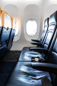 飞机内部带现代皮椅的机舱供飞机乘客使用背景图片