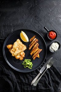 传统的英国热菜炸鱼薯片糊状薄荷豌豆和鞑靼酱和番茄酱从上面看图片