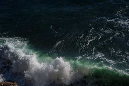 海浪背景打破海水岩石海岸波涛汹涌的大海绿松石水梯度泡沫在公海的大浪夏季风海背景图片