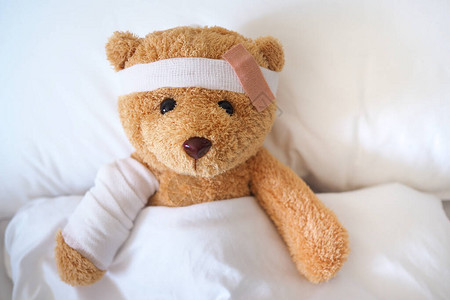 泰迪熊生病在床上他的手臂断了头部图片