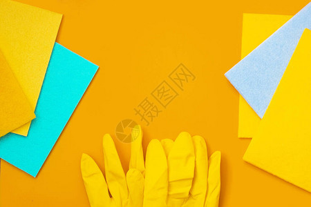 蓝色和黄色抹布橙色背景的黄色手图片
