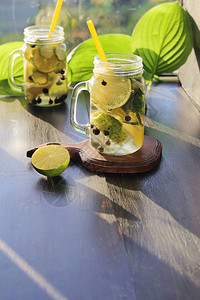 冷饮木制桌上玻璃杯中的柠檬黄瓜和薄荷图片