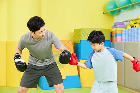 男孩和教练一起进行拳击训练图片