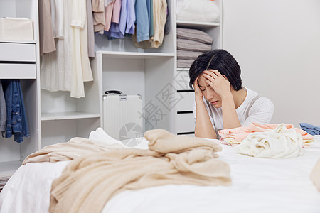 居家女性收拾衣物感到烦躁图片