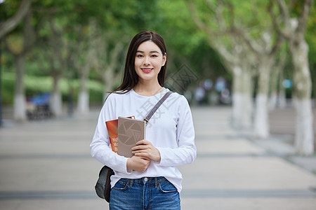 抱着书本的学生抱着书本的女学生形象背景