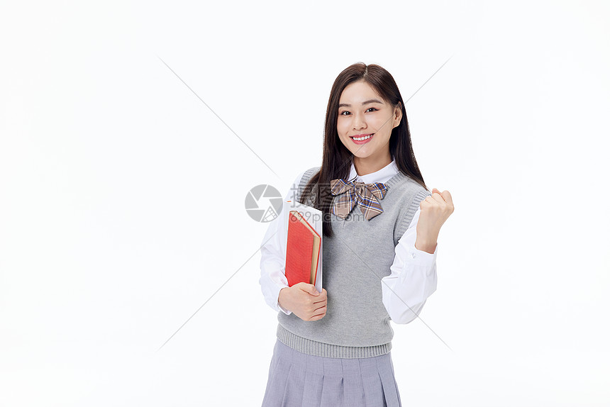 抱着书本加油的女学生图片