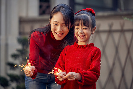 母女在院子里放烟花高清图片