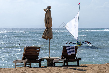 巴厘岛海滩伞下的空椅子图片