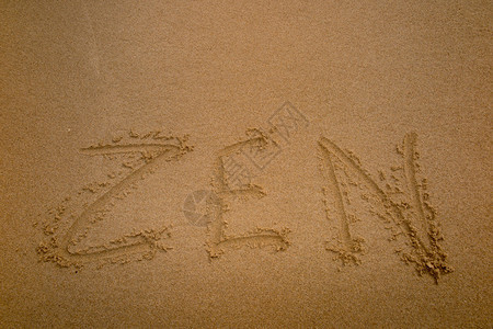 写在沙滩上的禅字背景图片