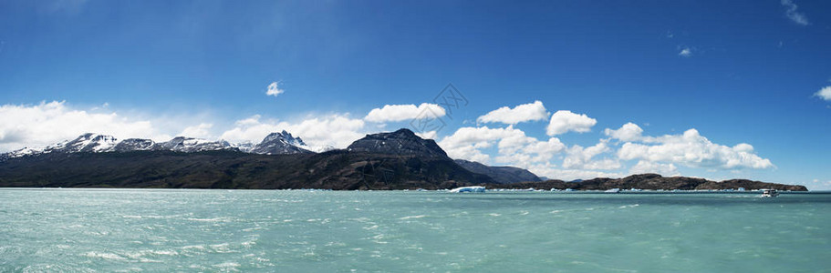 阿根廷最大的淡水湖阿根廷湖的漂浮冰山船和水晶般清澈的水图片