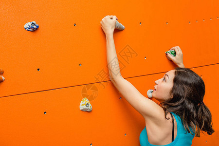 在巨石攀岩墙上开始的女登山图片