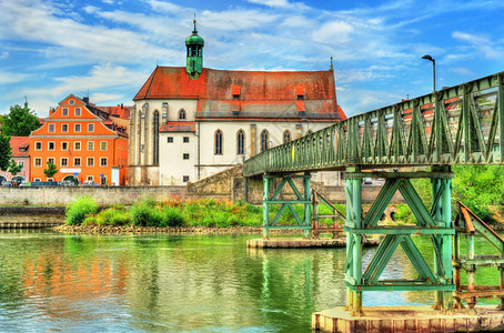 圣奥斯瓦尔德教堂与EisernerSteg桥横跨在雷根斯堡的多瑙图片