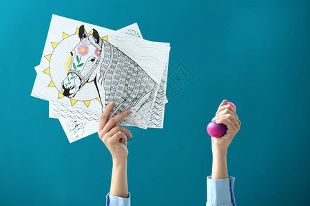 彩色背景上有zentangles和压力球的女手图片