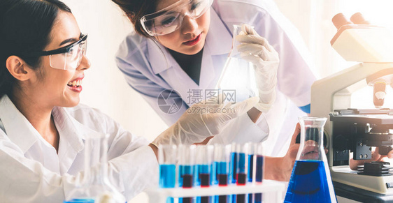 一组科学家穿着实验室外套在实验室工作同时检查试管和科学仪器中的生物化学样品科学技术研发研究理念图片