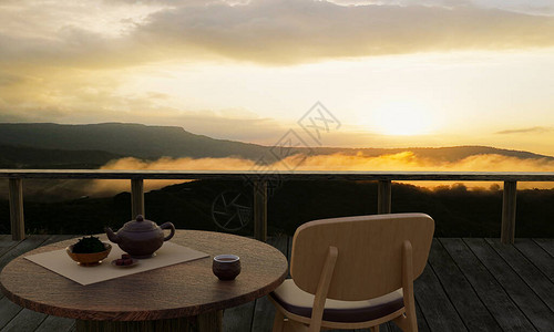 陶瓷茶具和干茶叶放在木头阳台或露台的木桌和椅子上晨雾和阳光的山景山上的热茶气氛背景图片