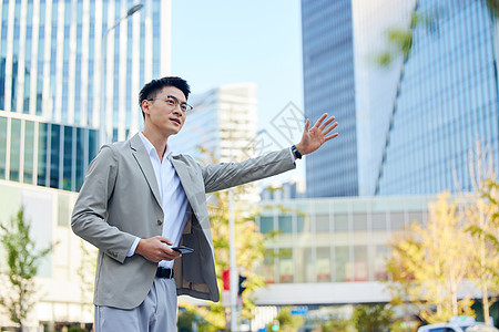 年轻商务男士路边等待打车形象背景