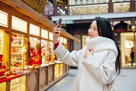 年俗年味青年女子庙会里闲逛玩耍自拍的女性背景