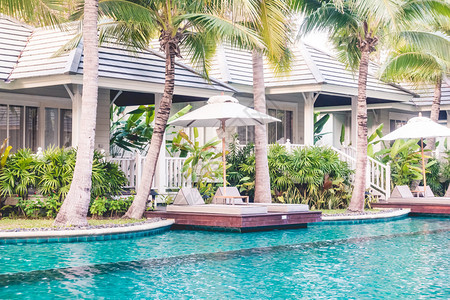 充气游泳池酒店泳池度假村游泳池周围美丽的豪华雨伞和椅子背景