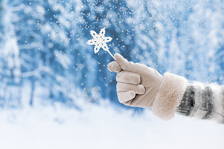 雪地里手拿雪花棒棒糖特写图片