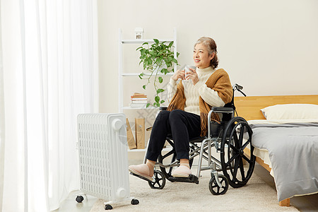 坐轮椅的奶奶居家使用暖气片高清图片
