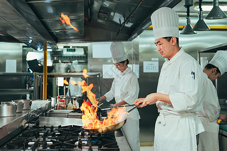 工作服餐饮后厨内的专业厨师团队烹饪美味佳肴背景