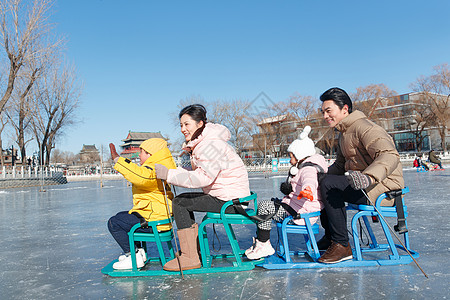 姐妹湖快乐的一家四口坐冰车玩耍背景
